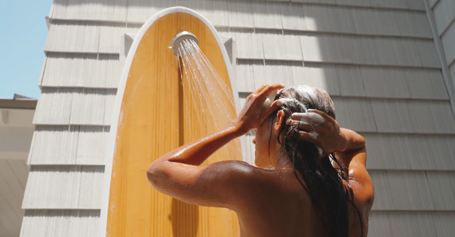 Load video: young couple using wash bloc in outdoor shower 
